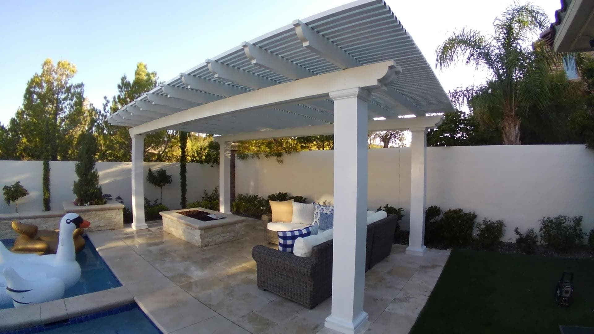 White Alumawood lattice patio cover beside a backyard pool