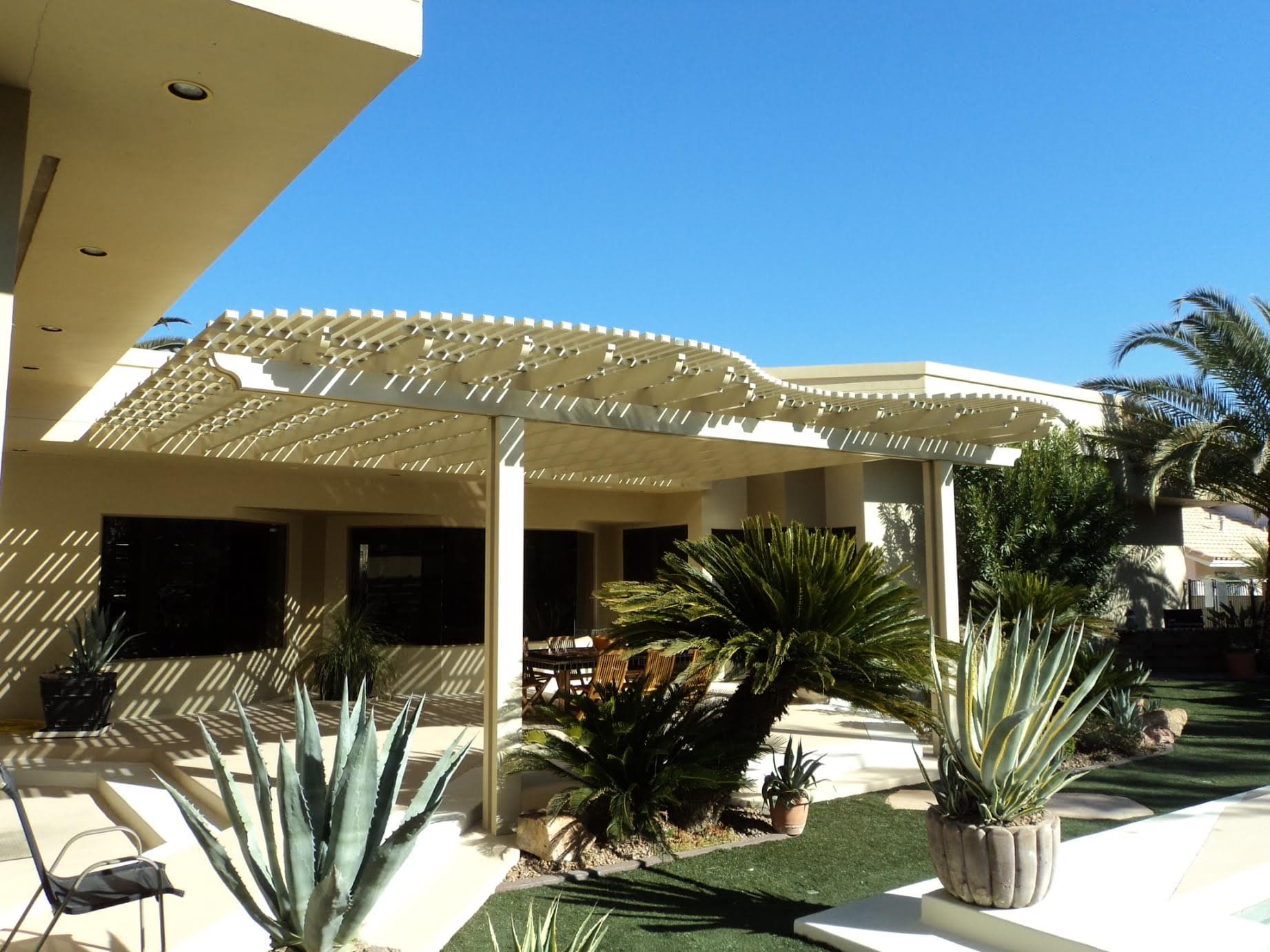 White lattice patio cover with a dining set and palms