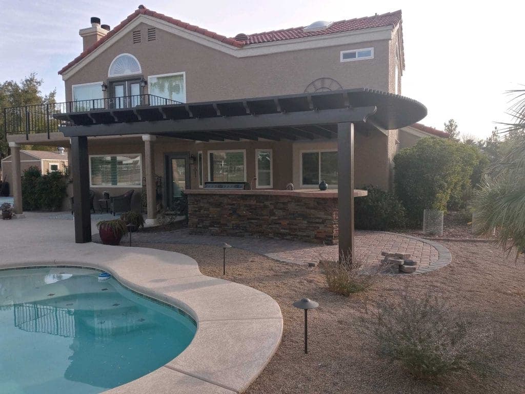 Solid patio cover beside a backyard pool