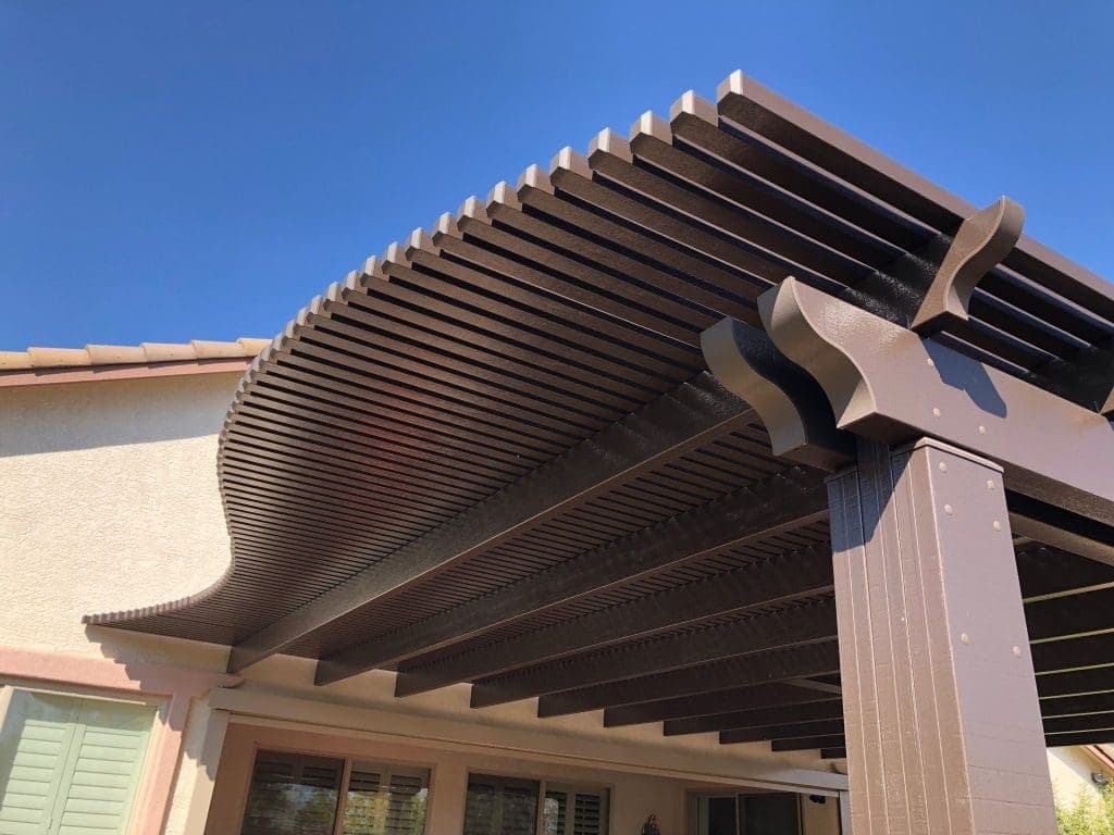 Dark-brown lattice rafter tails against the sky