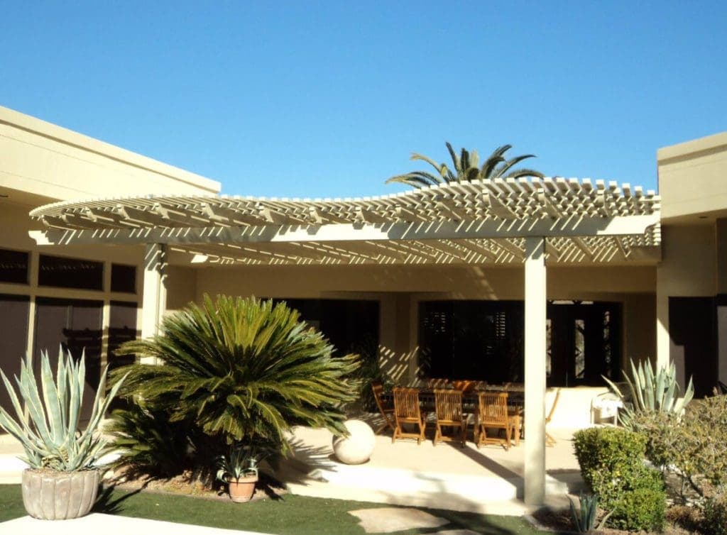 Freestanding lattice patio cover beside palms