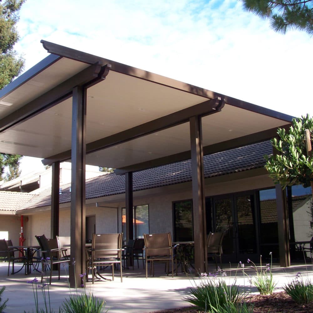 Freestanding Spanish brown Alumawood solid cover over an outdoor seating area
